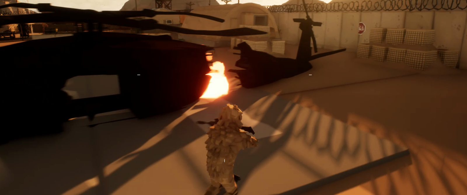 An operator running past a burning helicopter